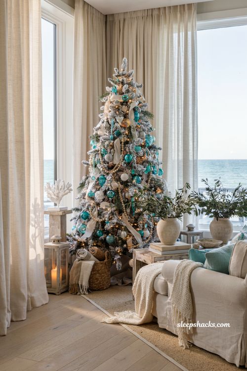 Coastal christmas living room with a flocked white tree and seaside holiday decor