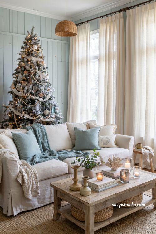 Coastal christmas living room with cable knit throws ivory pillows and cozy seaside holiday decor