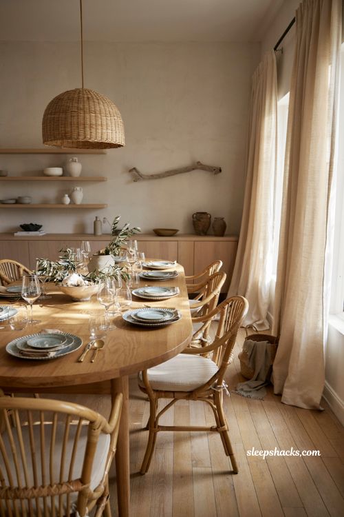 Coastal dining table with blue and white tableware woven chairs and natural wood decor