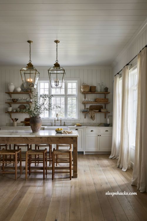 Coastal farmhouse kitchen ideas with aged brass lantern pendant lights over island