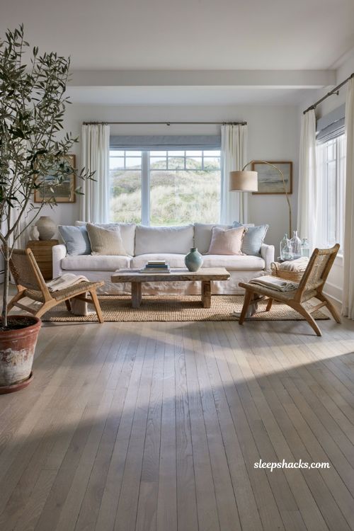 Coastal-inspired living room with blue ticking stripe cushions and neutral decor