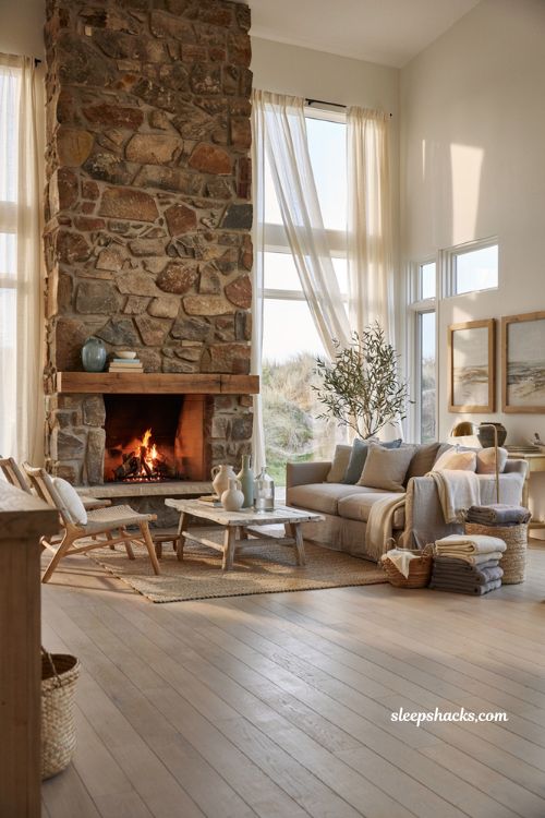 Coastal-inspired living room with natural stone fireplace and soft neutral coastal decor