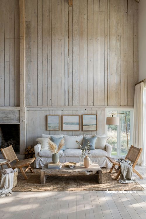 Coastal-inspired living room with whitewashed wood paneling and slipcovered sofa