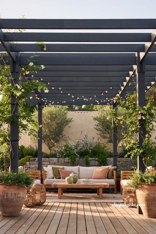 Colorful backyard ideas with charcoal pergola and modern outdoor lounge