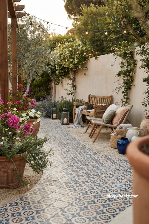Colorful backyard ideas with patterned tiled patio walkway and vibrant garden path