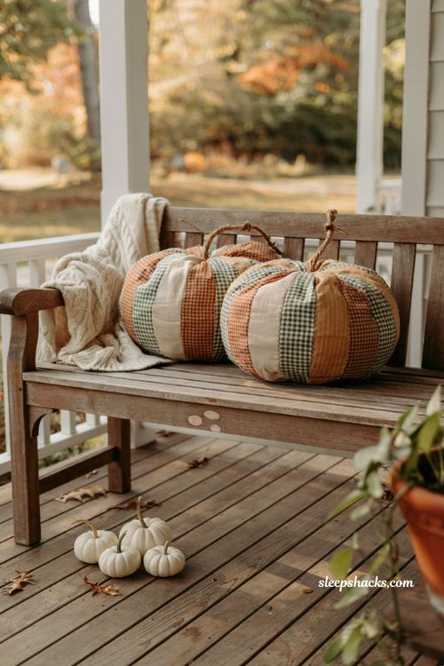 Diy patchwork pumpkin pillows on a cozy porch bench for fall decor