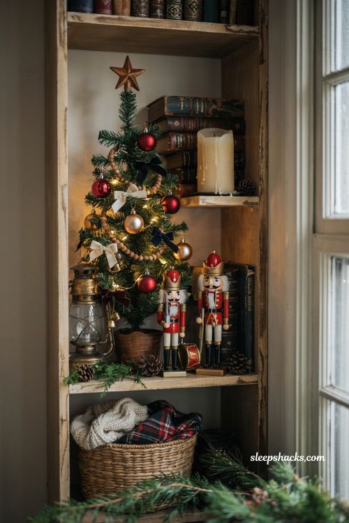 Dollar tree mini christmas tree ideas with miniature nutcracker decorations on a cozy bookshelf
