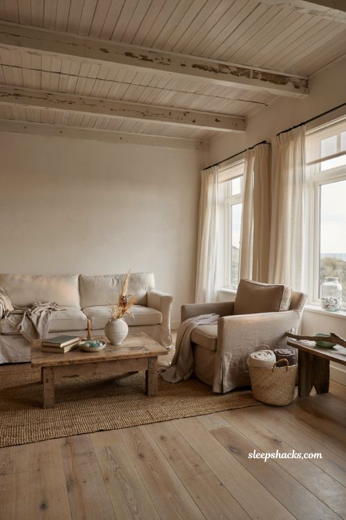 Dreamy coastal aesthetic living room with light washed wood soft linen decor and natural seaside textures