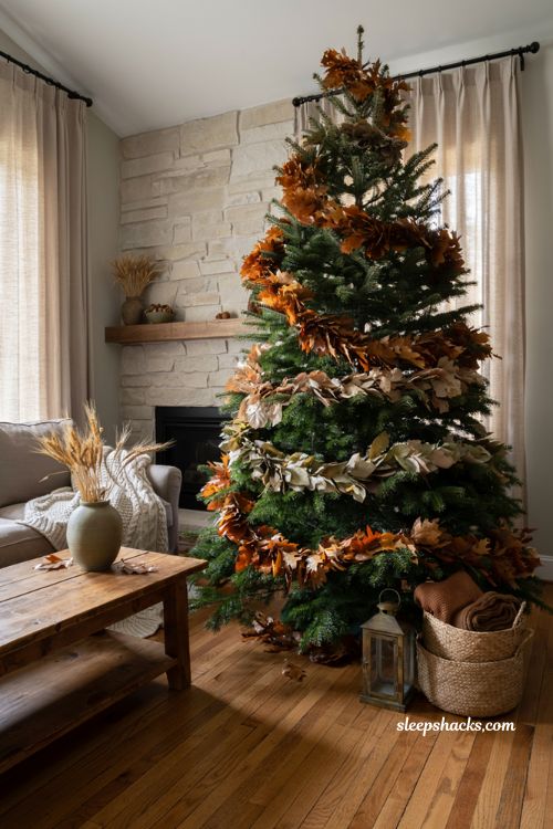 Fall christmas tree ideas with layered autumn leaf garland in a cozy farmhouse living room