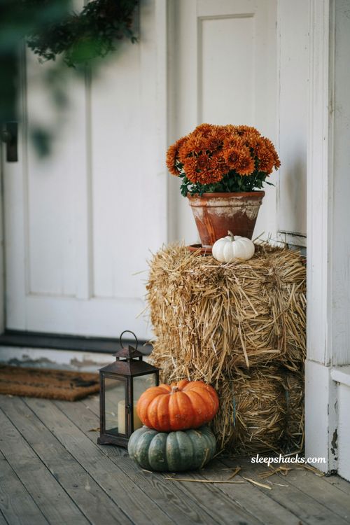Fall front porch decor with a hay bale display stand for potted mums and pumpkins