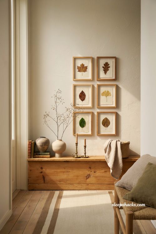 Fall home decor ideas with pressed autumn leaves gallery wall above a console table