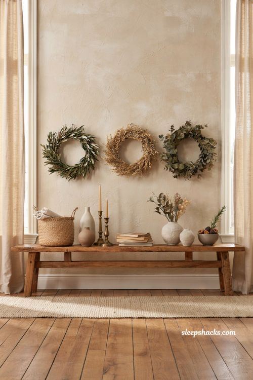 Fall home decor ideas with three matching wreaths above a console table