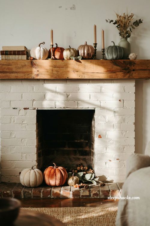 Fall mantle decor with faux pumpkins in mixed matte velvet and metallic finishes for a cozy farmhouse fireplace