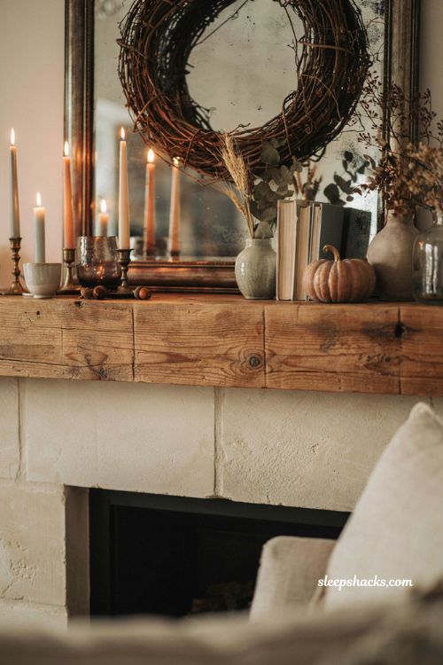 Fall mantle decor with mixed-height taper candles and vintage candlesticks for a cozy farmhouse fireplace