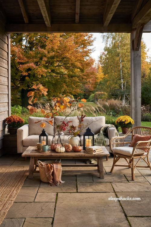 Fall patio decor with a vase of autumn branches and cozy outdoor styling