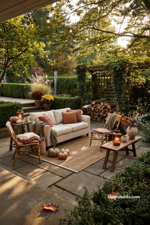 Fall patio decor with cozy blankets pumpkins and warm outdoor seating