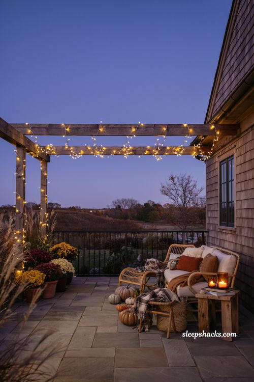 Fall patio decor with warm string lights and cozy evening ambiance