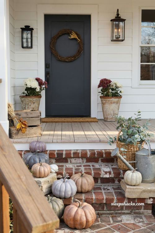 Fall porch decorating ideas with custom painted pumpkins in elegant autumn colors