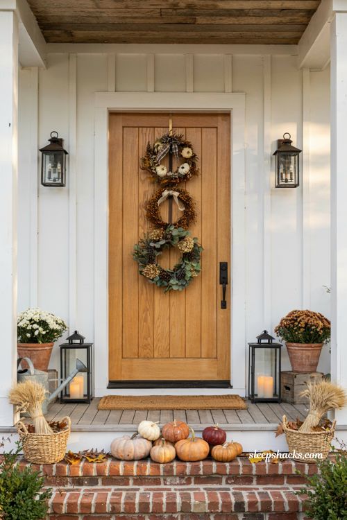 Fall porch decorating ideas with layered autumn wreath display on front door