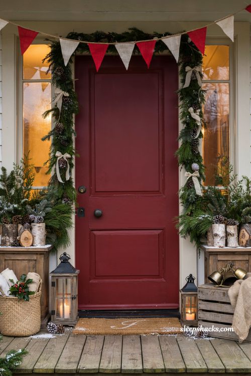 Farmhouse Christmas front door ideas with burlap pennant garland and personalized coir doormat