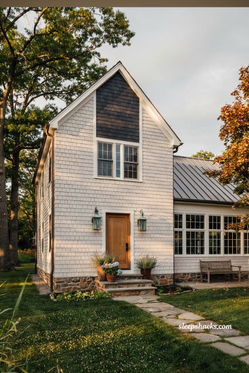 Farmhouse exterior ideas featuring a two story silhouette with steep gable and a lower one story porch wing