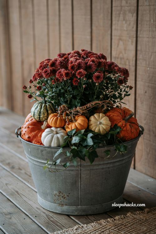Farmhouse style galvanized tub filled with fall mums and heirloom pumpkins for outdoor decor ideas