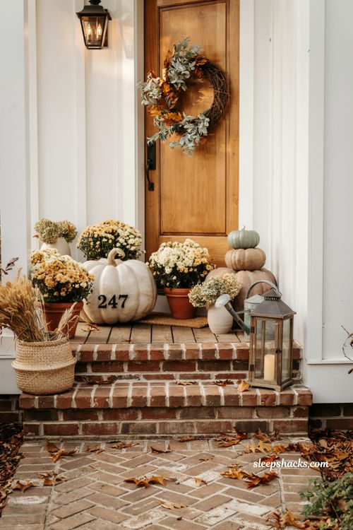 Front porch fall decorating ideas with personalised pumpkin house numbers and white mums