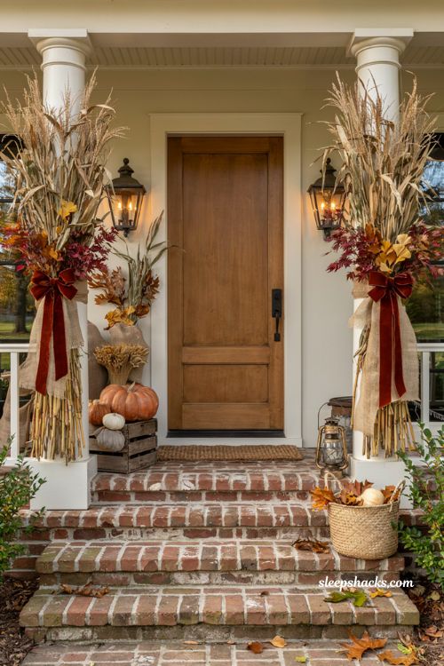 Front porch fall decorating ideas with tall cornstalks on porch pillars