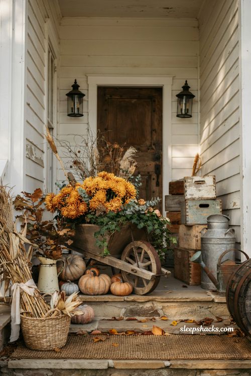 Front porch fall decorating ideas with vintage wheelbarrow and rustic autumn vignette