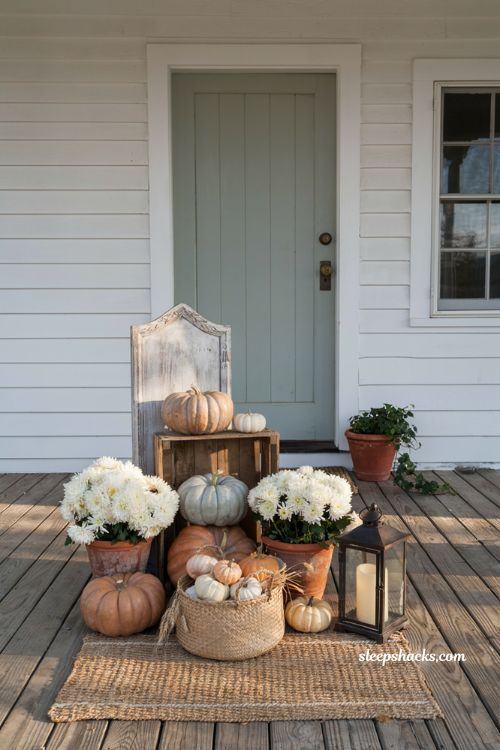 Front porch pumpkins display ideas with a rustic wooden welcome sign