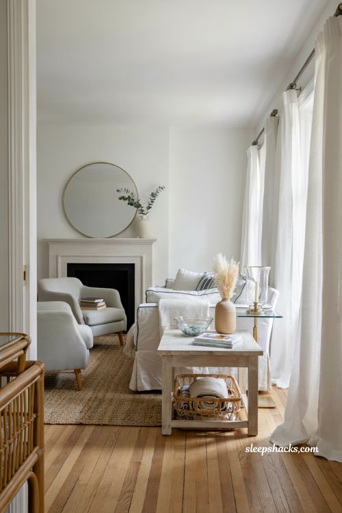 Hamptons style coastal living room with white linen sofas and airy light filled decor