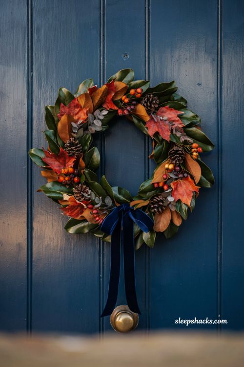 Handcrafted fall wreath ideas with red maple and magnolia leaves matching front door