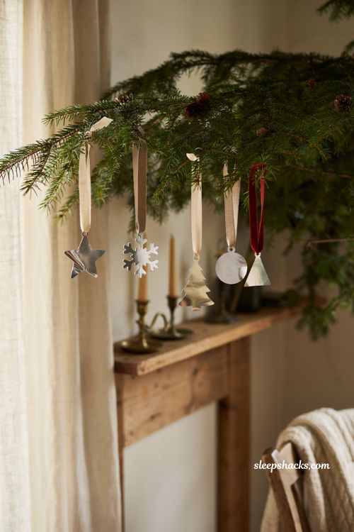 Handmade aluminum can christmas ornaments on a rustic farmhouse tree with recycled holiday decor