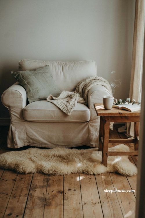 Hygge Christmas living room textile ideas with chunky knit throws and sheepskin rugs