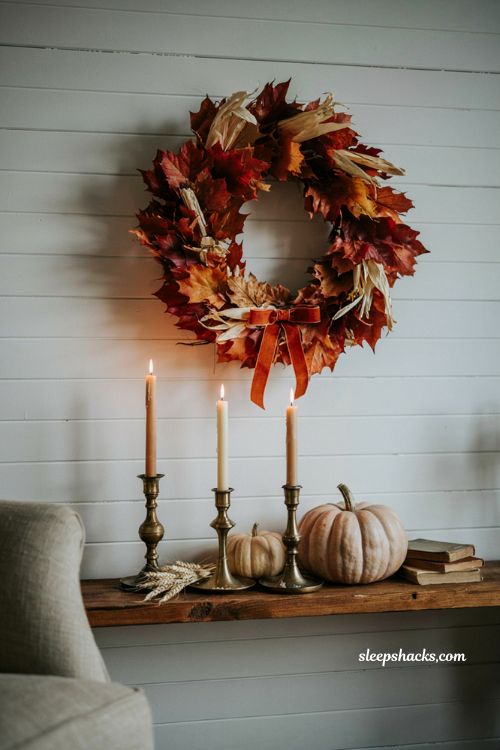 Indoor autumn leaf wreath hung above living room mantel for cozy wall decor