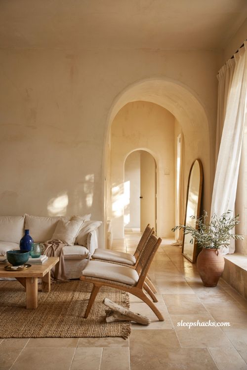 Mediterranean coastal living room with arched doorway textured plaster walls and warm seaside decor