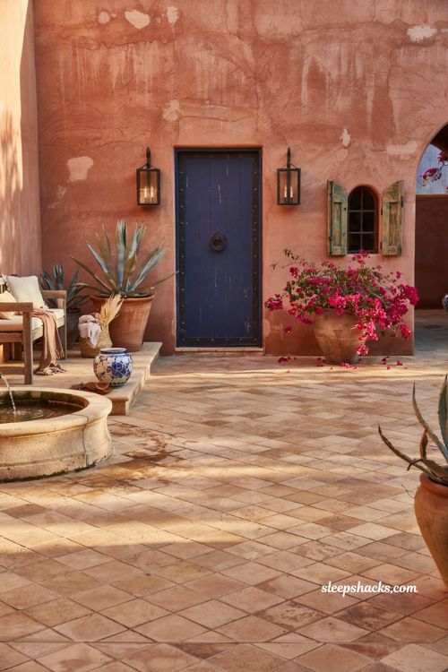 Mexican patio blueprint with terracotta walls and cobalt blue courtyard door
