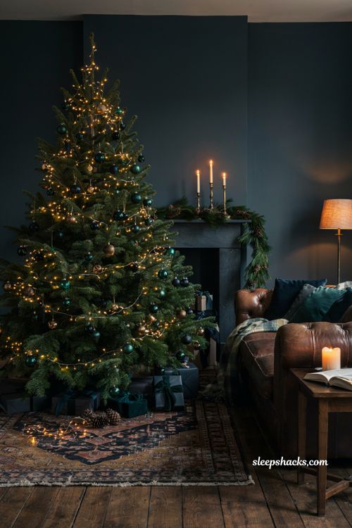 Moody dark tone Christmas living room decor idea with navy charcoal forest green palette and warm lights