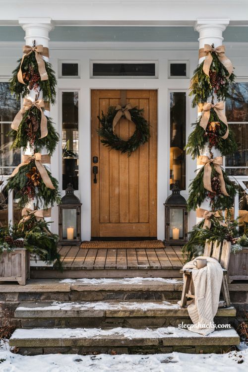 Outdoor christmas porch columns wrapped with evergreen garland burlap ribbon and pinecones