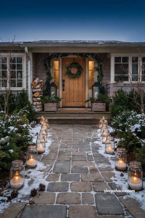 Outdoor christmas walkway lined with mason jar votive candles and cozy winter path decor
