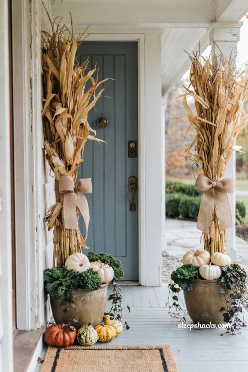 Outdoor fall porch decor ideas bundling dried corn stalks on posts with white pumpkins