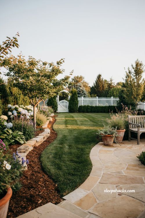 Outdoor landscaping ideas with fresh mulch garden beds and modern cottage backyard design