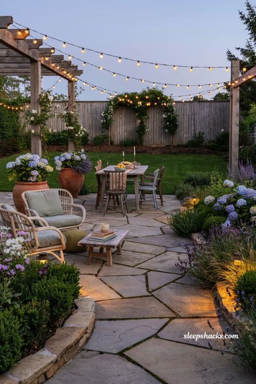 Outdoor landscaping ideas with overhead string lights and cozy modern cottage backyard patio