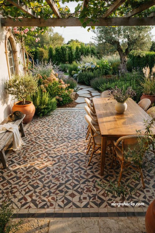 Outdoor landscaping ideas with patterned tile patio and modern Mediterranean cottage backyard