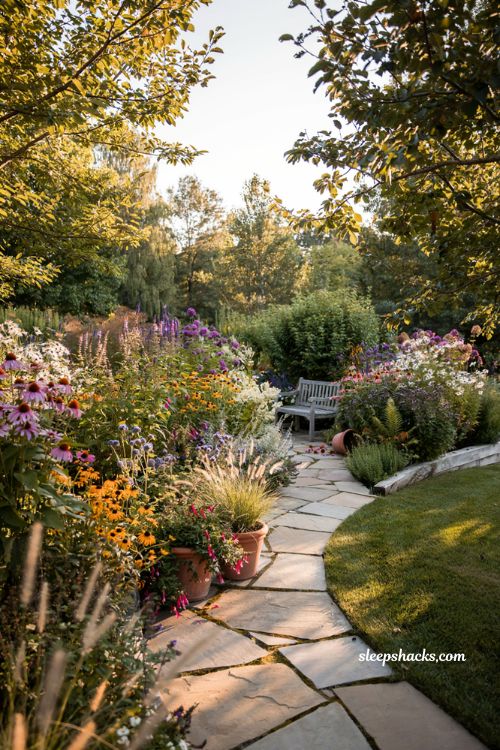 Outdoor landscaping ideas with stone and brick garden bed edging for a modern cottage backyard
