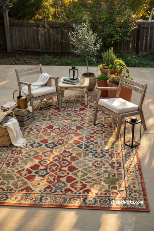 Patio decorating ideas on a budget with colorful flat weave outdoor rug and cozy seating