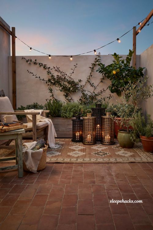 Patio decorating ideas on a budget with decorative lanterns and warm flameless candle glow