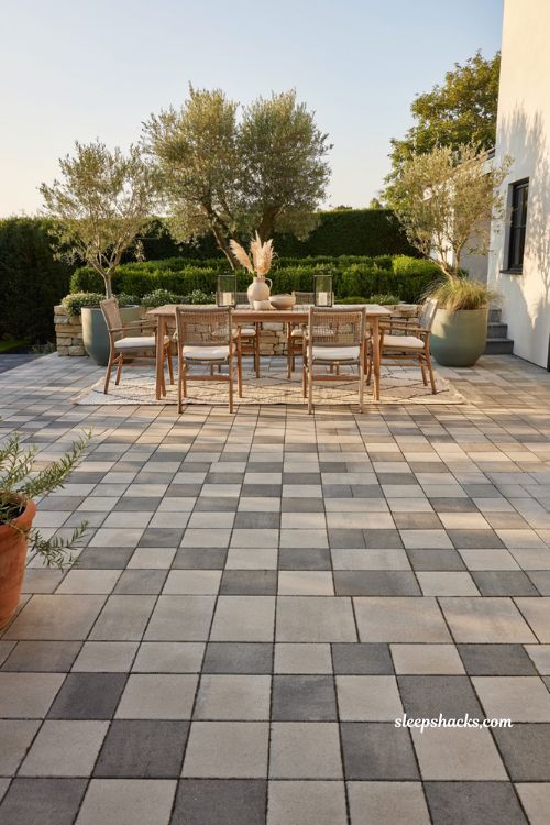 Paver patio ideas on a budget with two tone checkerboard concrete pavers and modern outdoor dining