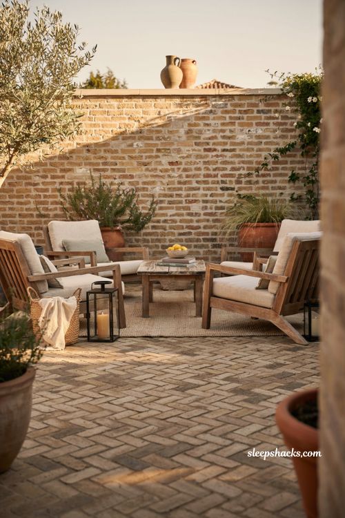 Paver patio ideas on a budget with low brick privacy wall and cozy backyard patio