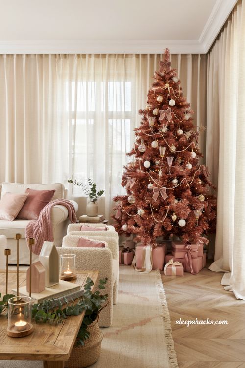 Pink christmas living room with a glamorous pink tinsel tree and cozy holiday decor